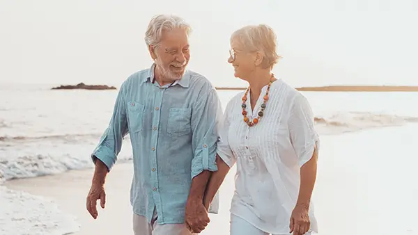 Older couple walking a beach